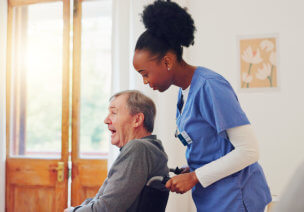 Female nurse push the wheelchair of the elder man