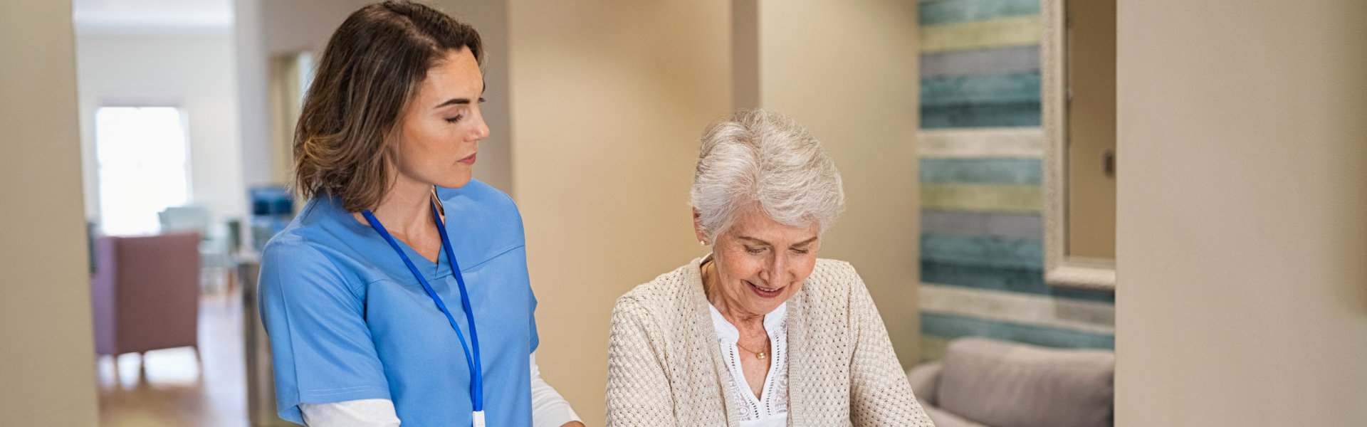 Female Nurse at home assist the elder woman  who used her crutches