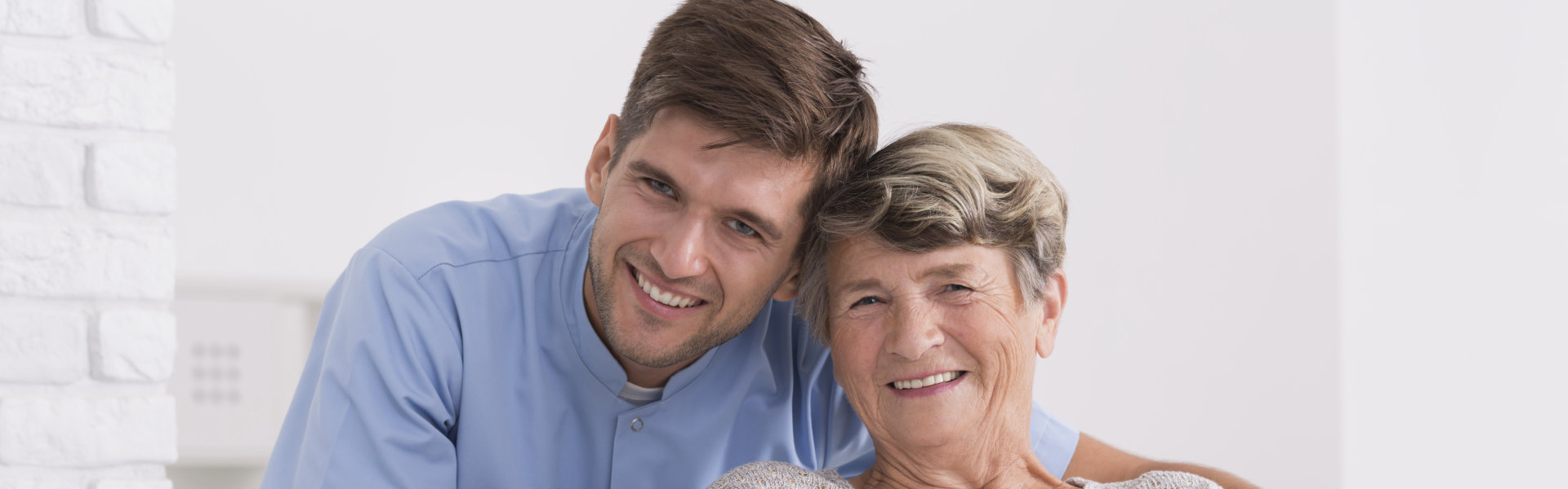 Male nurse and elder woman are smiling