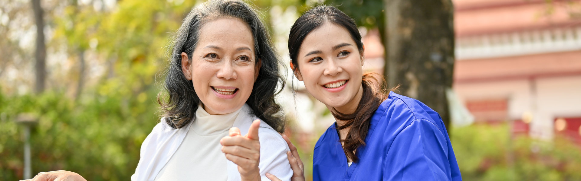 Happy elderly enjoys talking with her caregiver